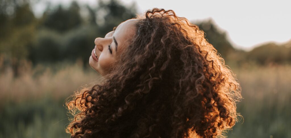 A woman smiling representing life after rehab.