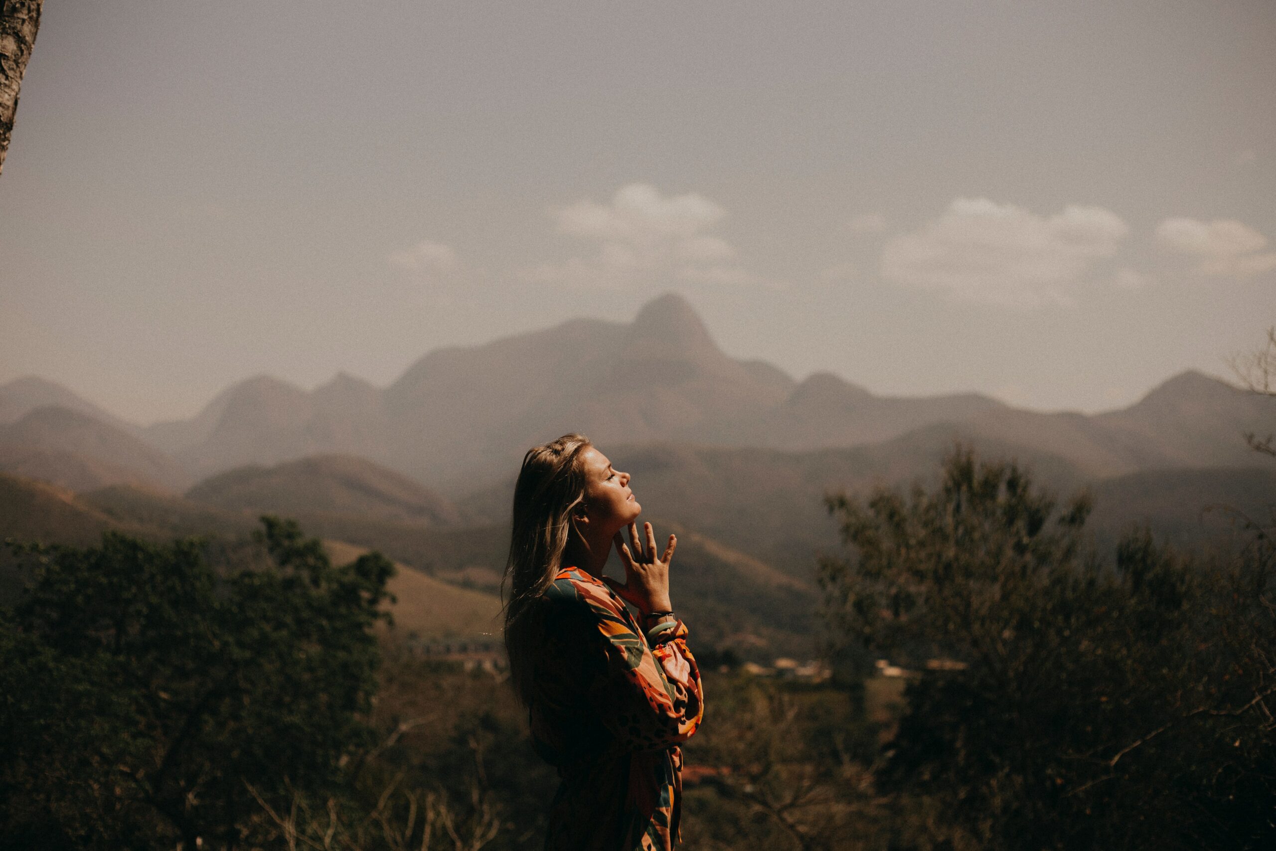 woman standing in the mountains wondering about the dangers of marijuana during recovery