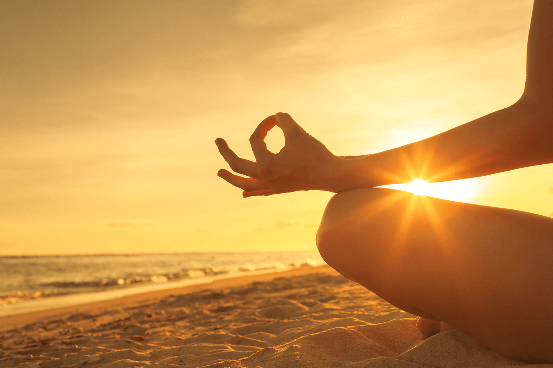 An image of someone meditating on the beach, showing the importance of mediation for addiction therapy