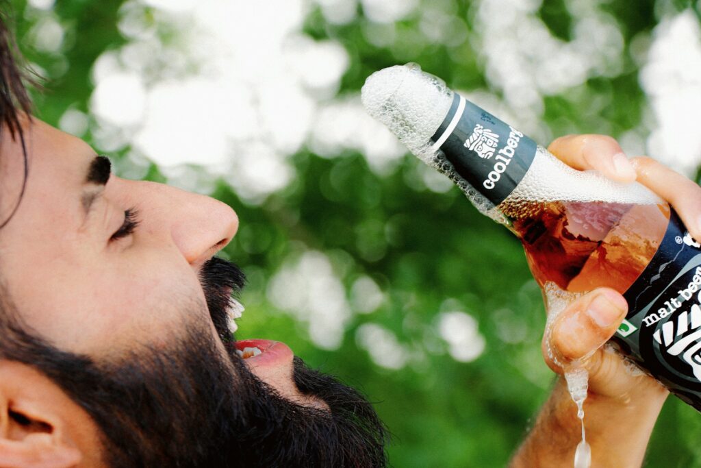 A man drinks a beer depicting the idea of beer goggles