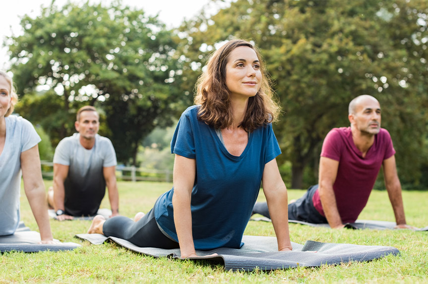 An image of yoga at the park, a sober activity