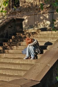 Demerol user sitting on stairs