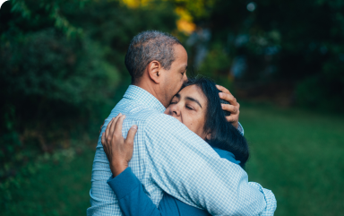 Two people embrace, one of them is helping a family member recover from addiction.
