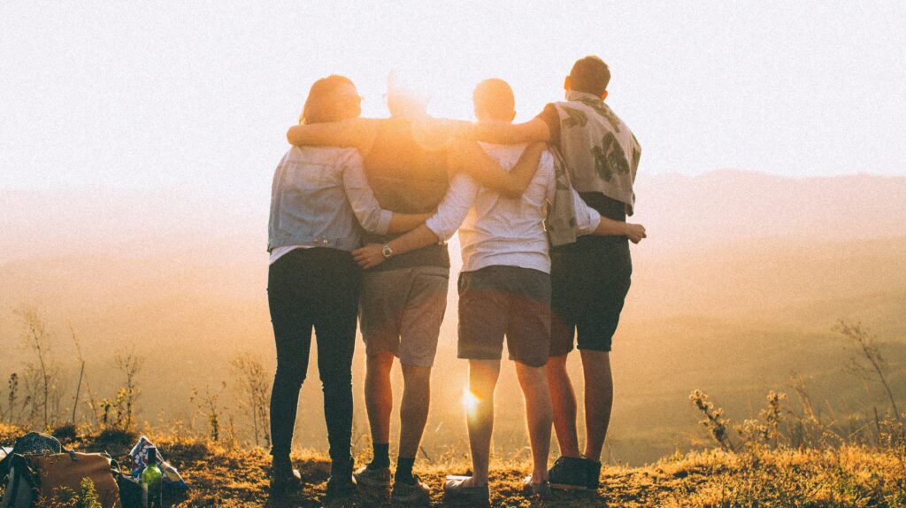A group of people stand with their arms around each other to represent Gratitude Lodge's fentanyl withdrawal treatment program in California.