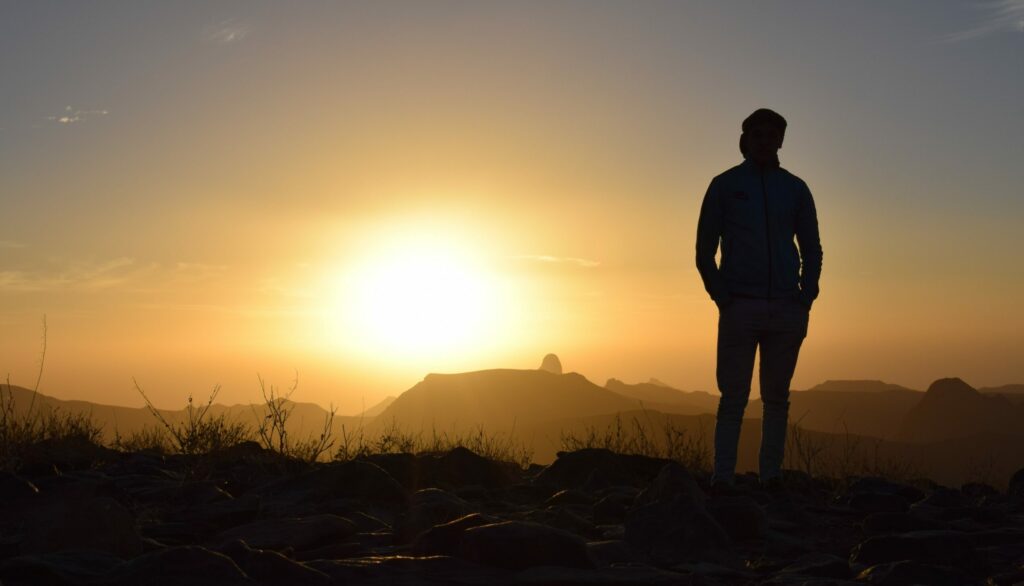 A man looks out at a landscape to represent fentanyl withdrawal symptoms.