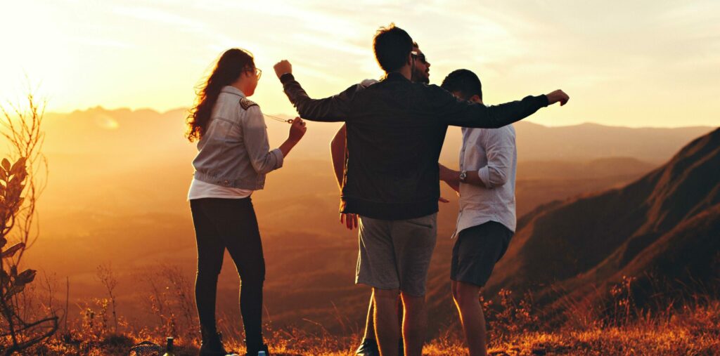 A group of people celebrate on a hillside at sunset to represent drug and alcohol rehab in southern California at Gratitude Lodge.