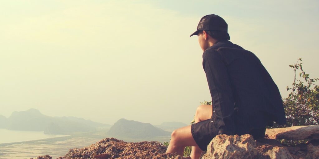 a man is looking out at a valley to represent codeine addiction.