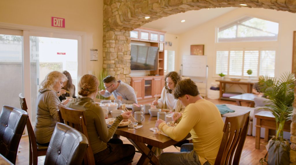 image of people sitting around a table to represent residential alcohol rehab in newport beach