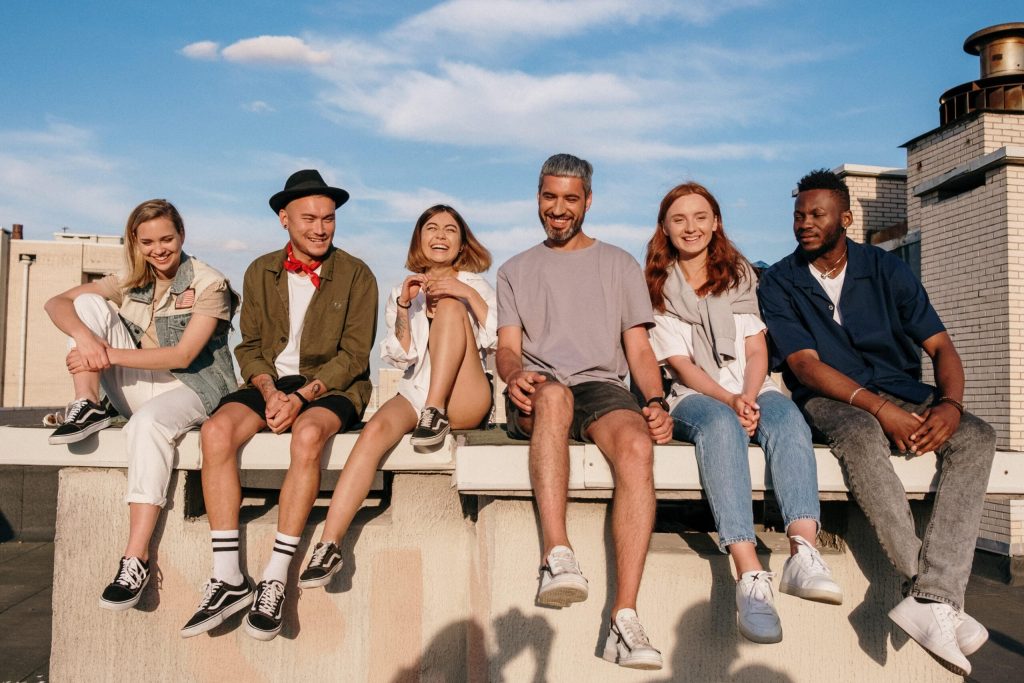 A group of people sit together on the beach to represent treatment for drug and alcohol addiction in Southern California at Gratitude Lodge.