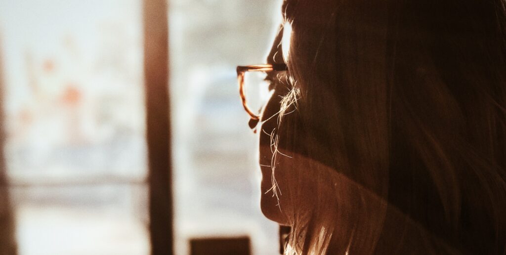 Woman looking out a window representing klonopin addiciton.