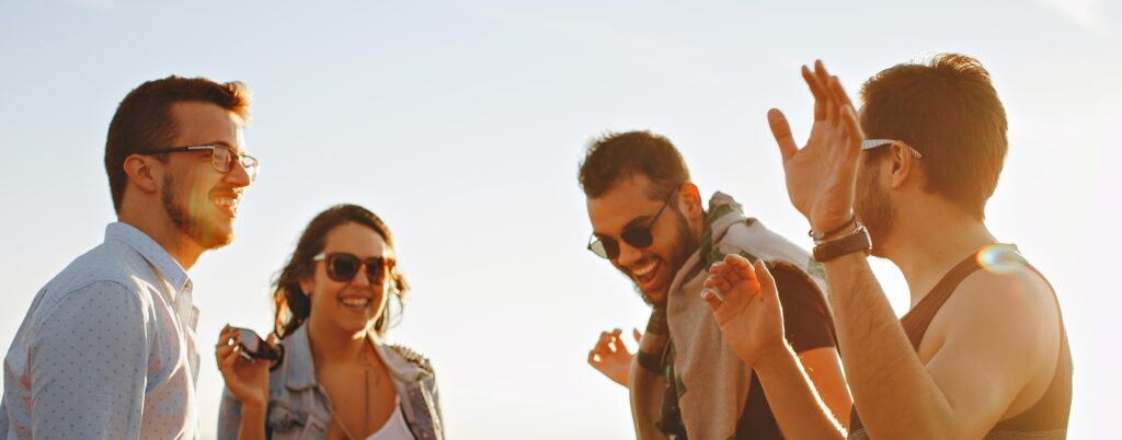 Group of friends celebrate representing What is sobriety