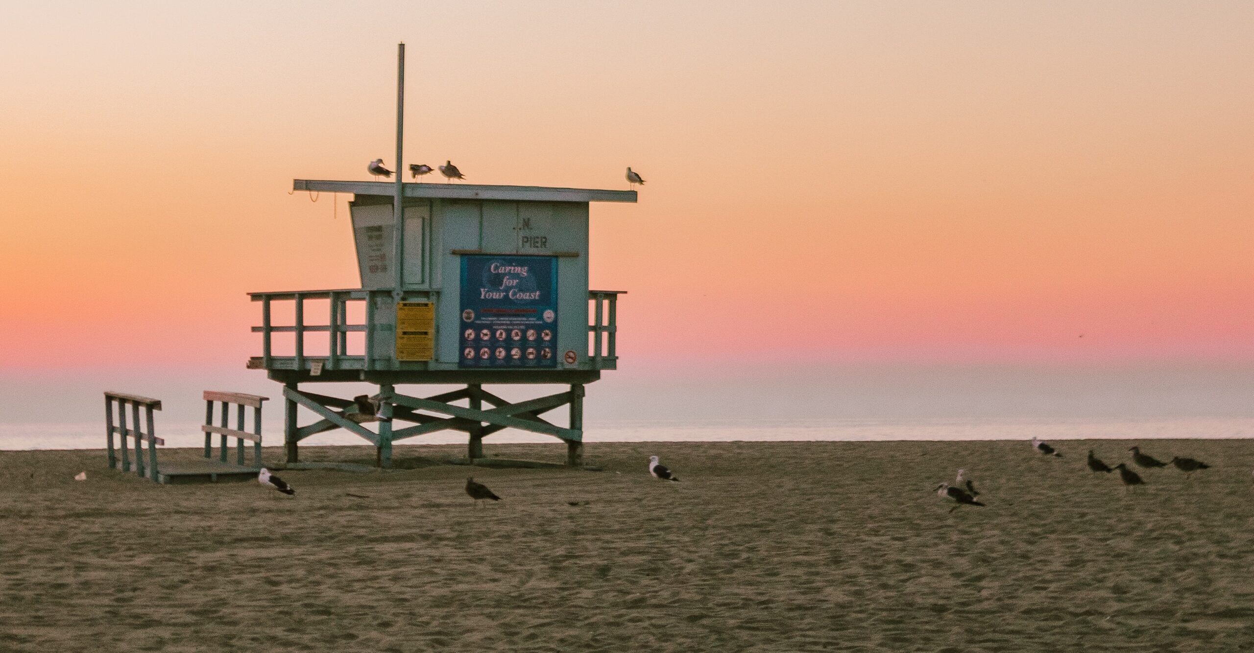A lifeguard post on laguna beach at sunset representing long beach opioids.