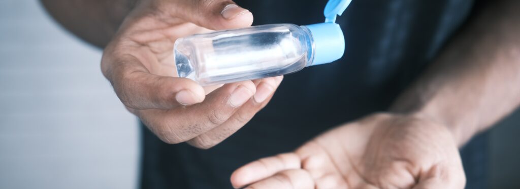 man cleaning hands representing drinking hand sanitizer