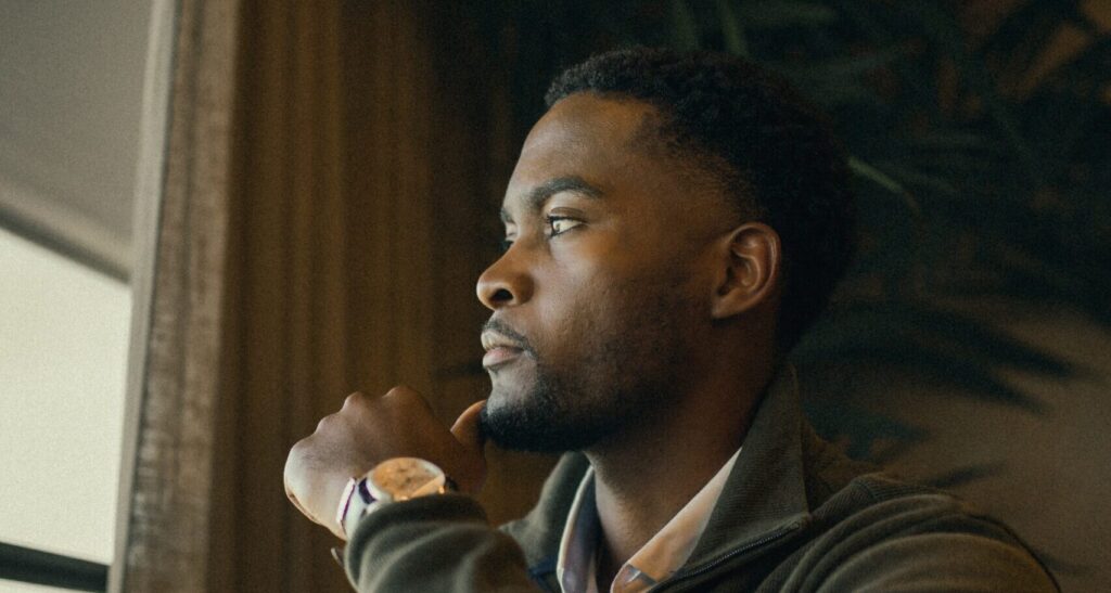 man looks out window representing tips for dry january