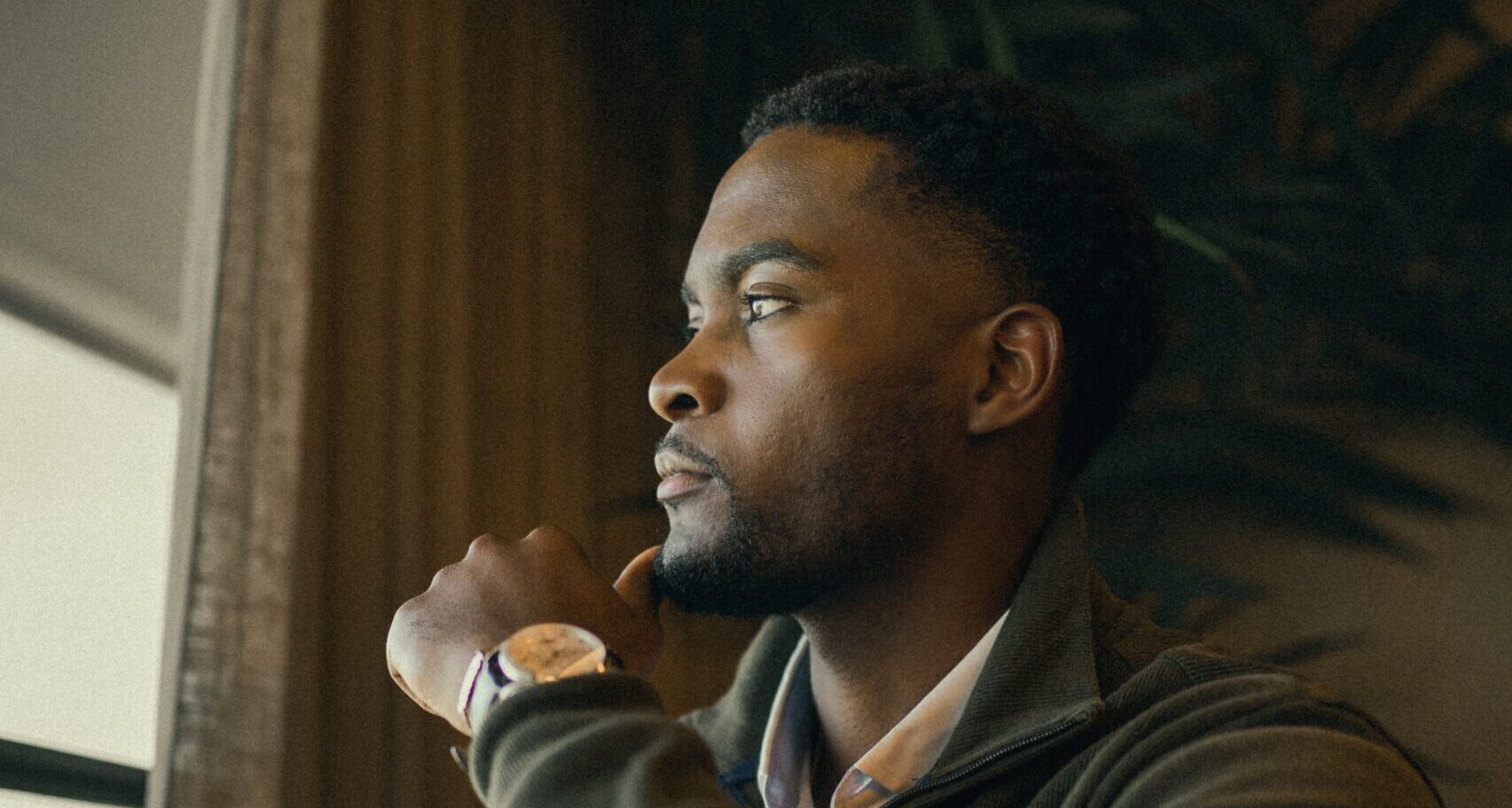 man looks out window representing tips for dry january