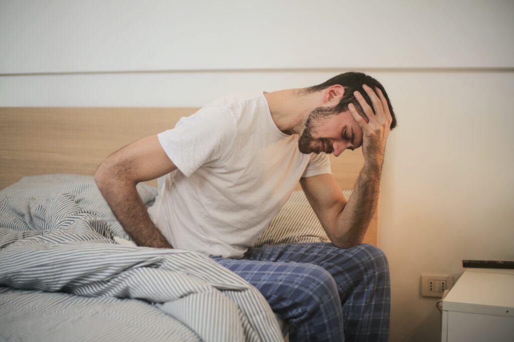 An image of a man struggling with the effects of alcohol abuse, including alcoholic face
