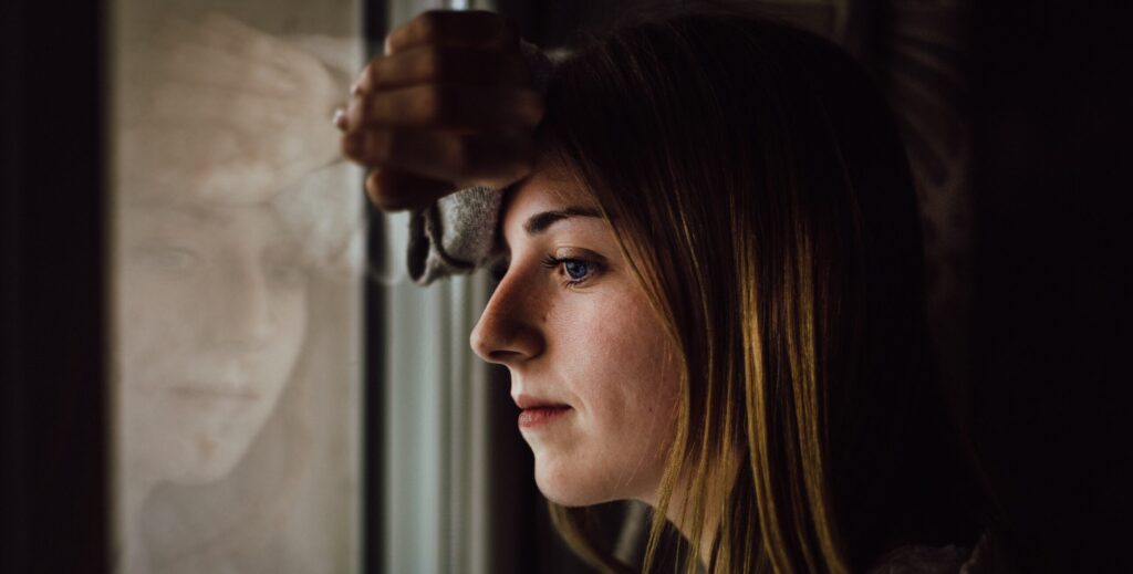 An image of a woman thinking about wellbutrin and alcohol.