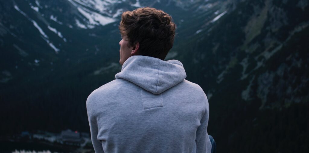 guy looks out on scenery representing alcohol and vicodin