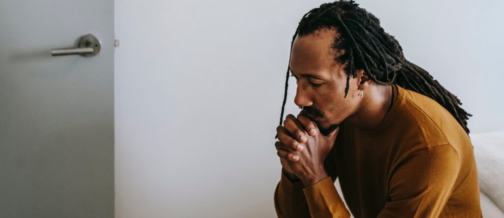 A man with folded hands, after he has learned about long term effects of ambien use