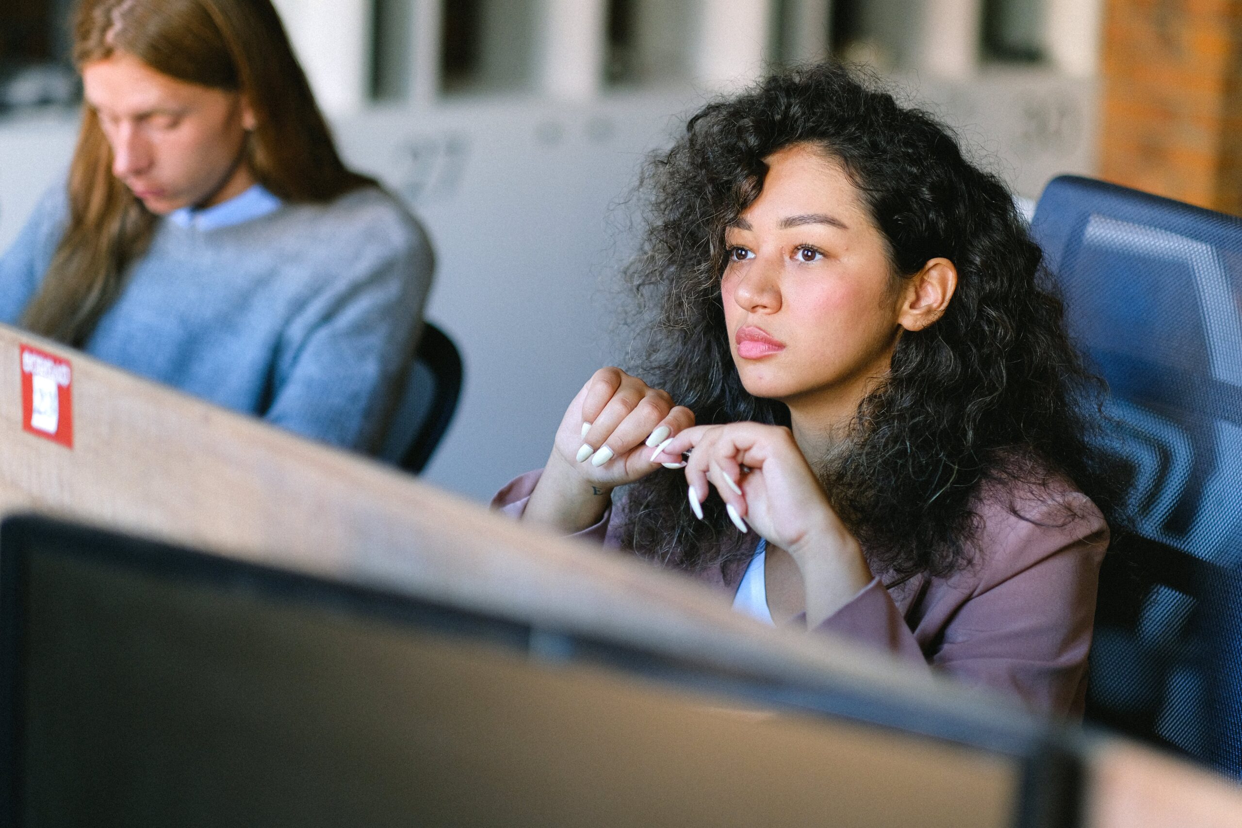 An image of a woman staring to the distance at work, as she thinks about Prozac withdrawal and how to avoid relapse