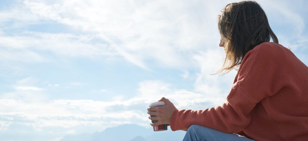A woman sits at the lake thinking about pcp effects