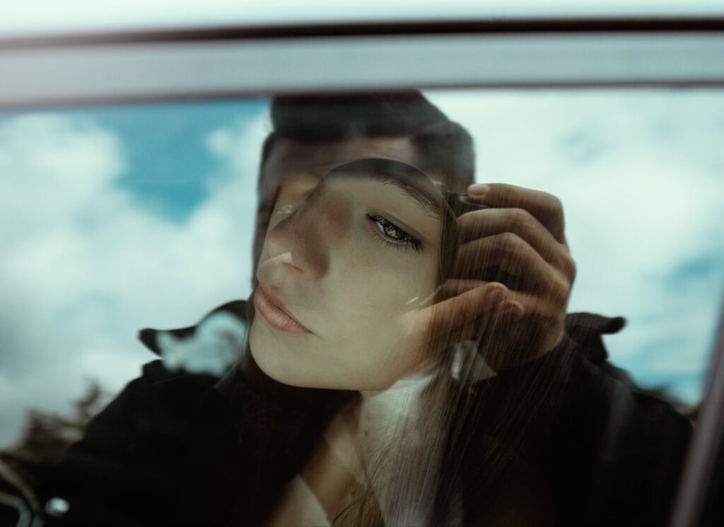 A woman reflecting after learning about the blue pills drug and blue percocet