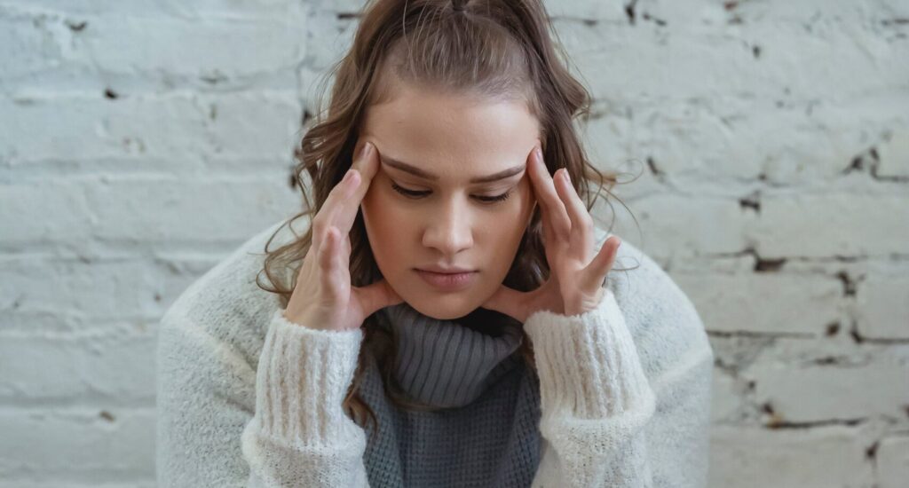 woman with hands on head representing prozac withdrawal timeline