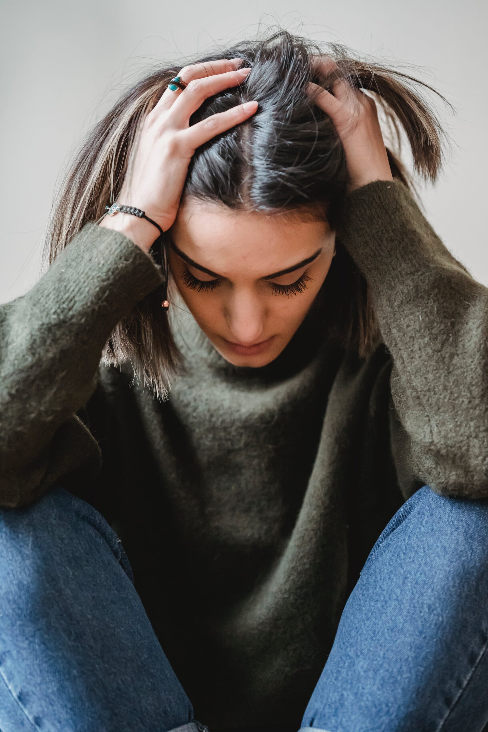 An image of a woman with her hands on her head, representing percocet addiction