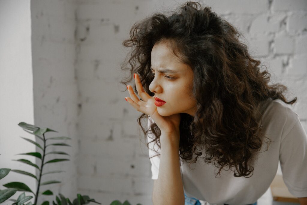 A woman in deep thought about the side effects and withdrawal symptoms of Vyvanse addiction