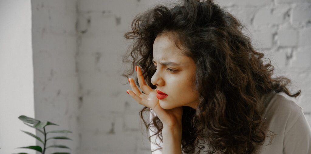 A woman in deep thought about the m30 pills