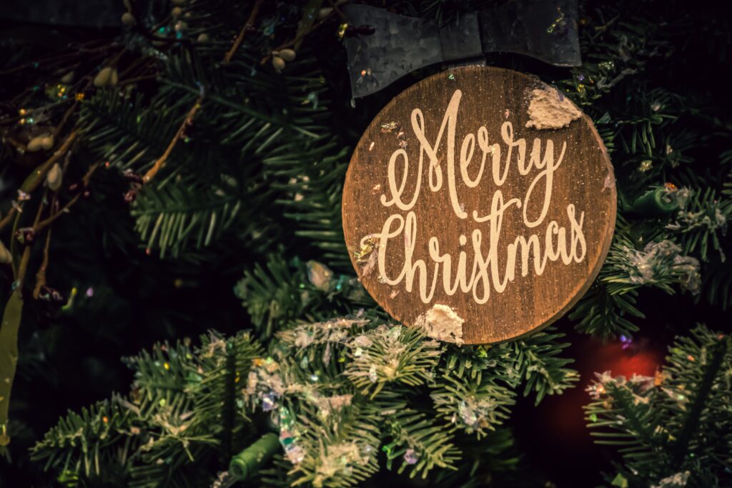 A tree ornament reading, "Merry Christmas", depicting the issue of maintaining a sober Christmas celebration