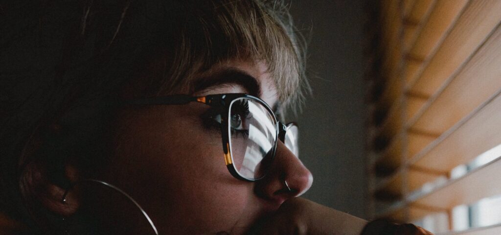 A woman staring out her window as she considers the Negative effects of cocaine
