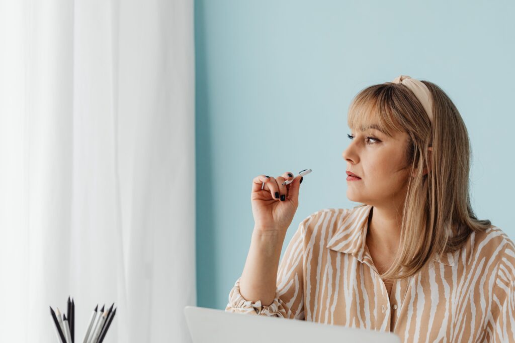 A woman distracted during work, depicting the alcohol effects on the brain