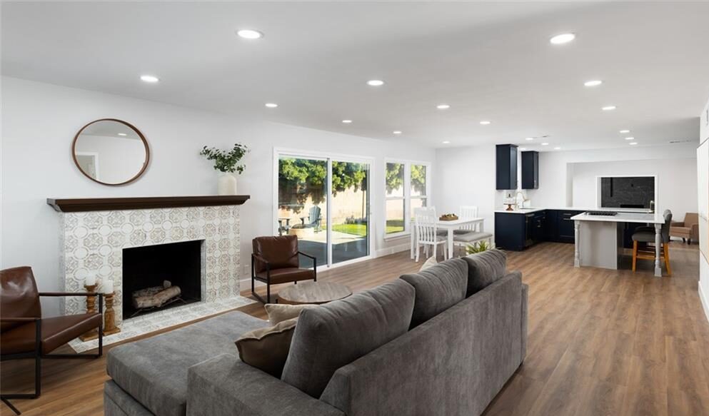 Image of a living room with a couch in front of a fireplace
