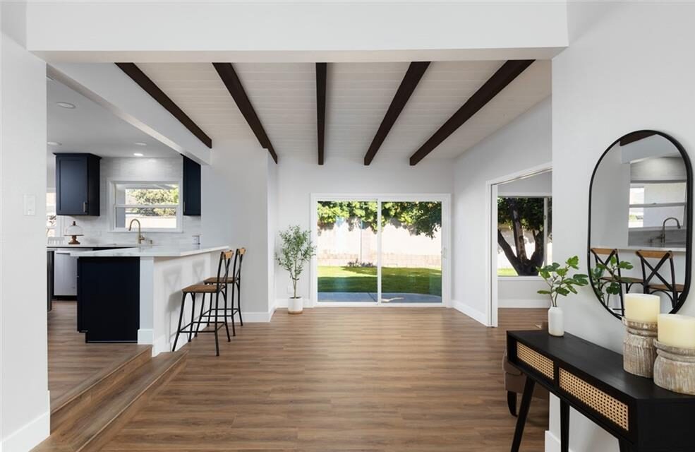 Image of the entry into a home with the kitchen on the left and back door straight ahead