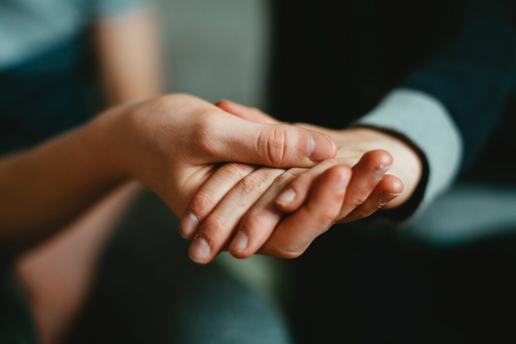 two people holding hands representing inpatient mental health facility