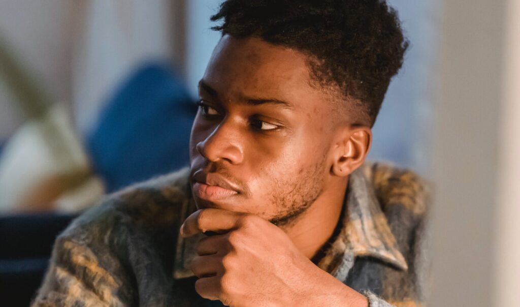A man appears curious, representing mixing dayquil with alcohol