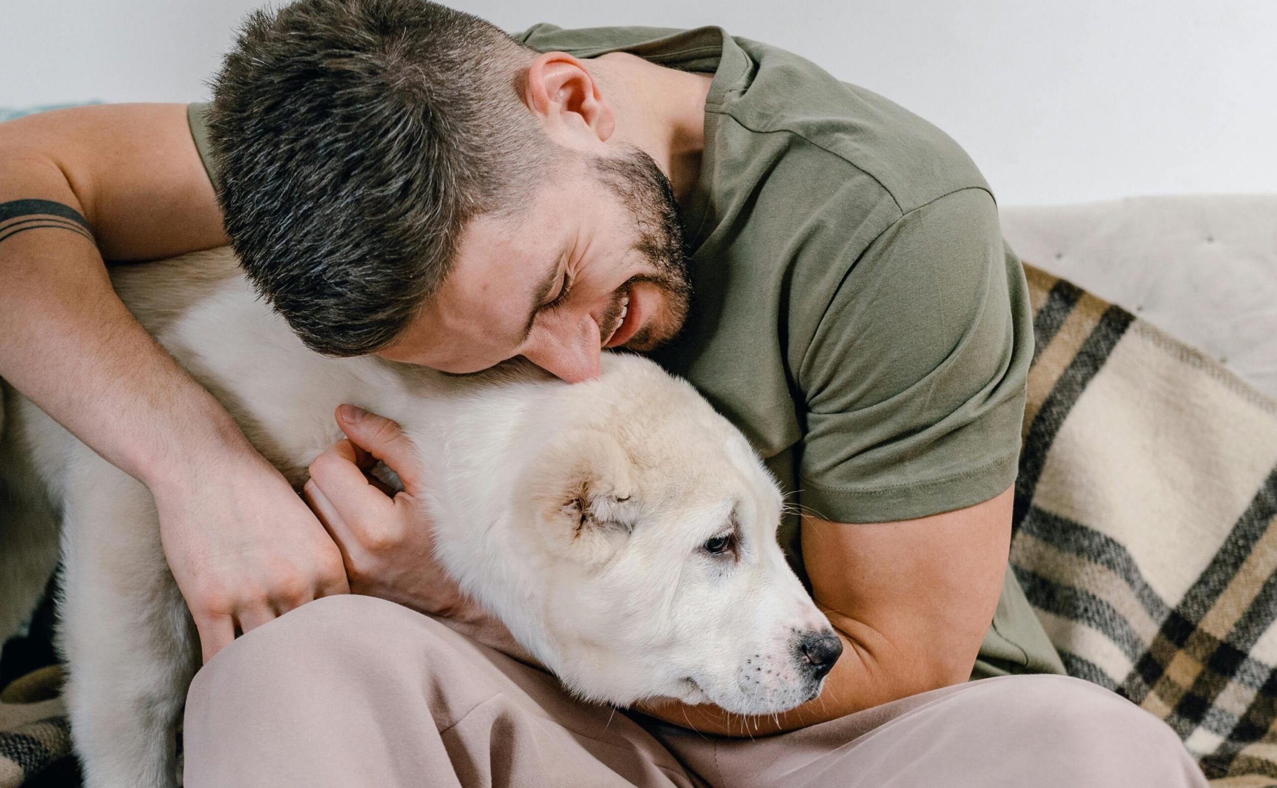 man hugging pet representing what to bring to rehab
