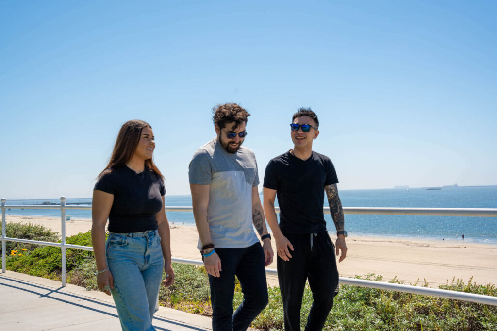 people walking near beach representing newport beach outpatient rehab