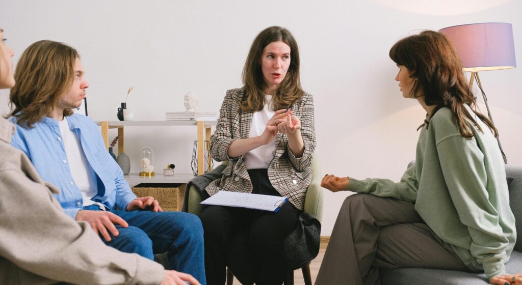 therapist and clients talking representing gratitude lodge team